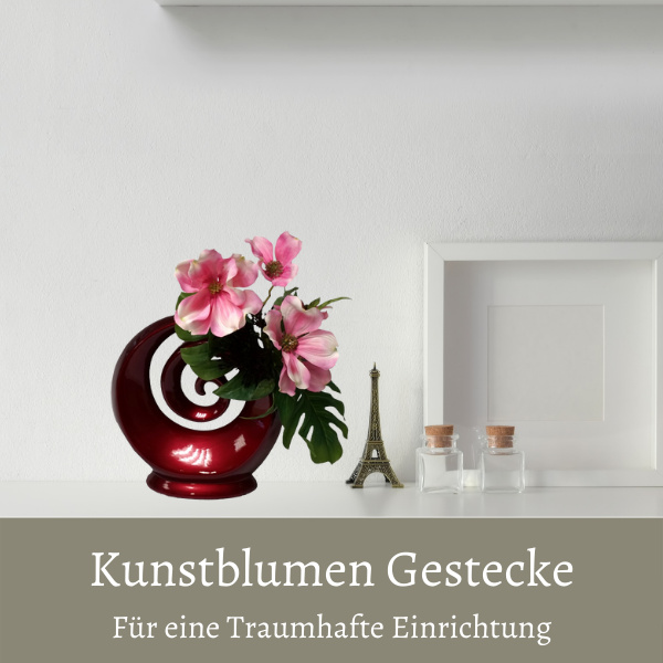Im Büro steht eine Kunstblumen Arrangement Clematis rosa in Keramikvase rot für eine elegante Einrichtung von dekotreff onlineshop